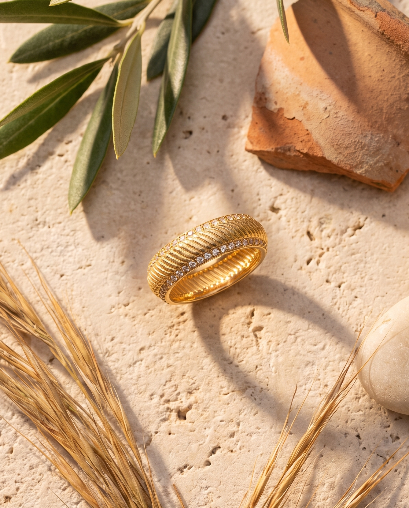 The Riviera Ring styled flat-lay with olive and Mediterranean props