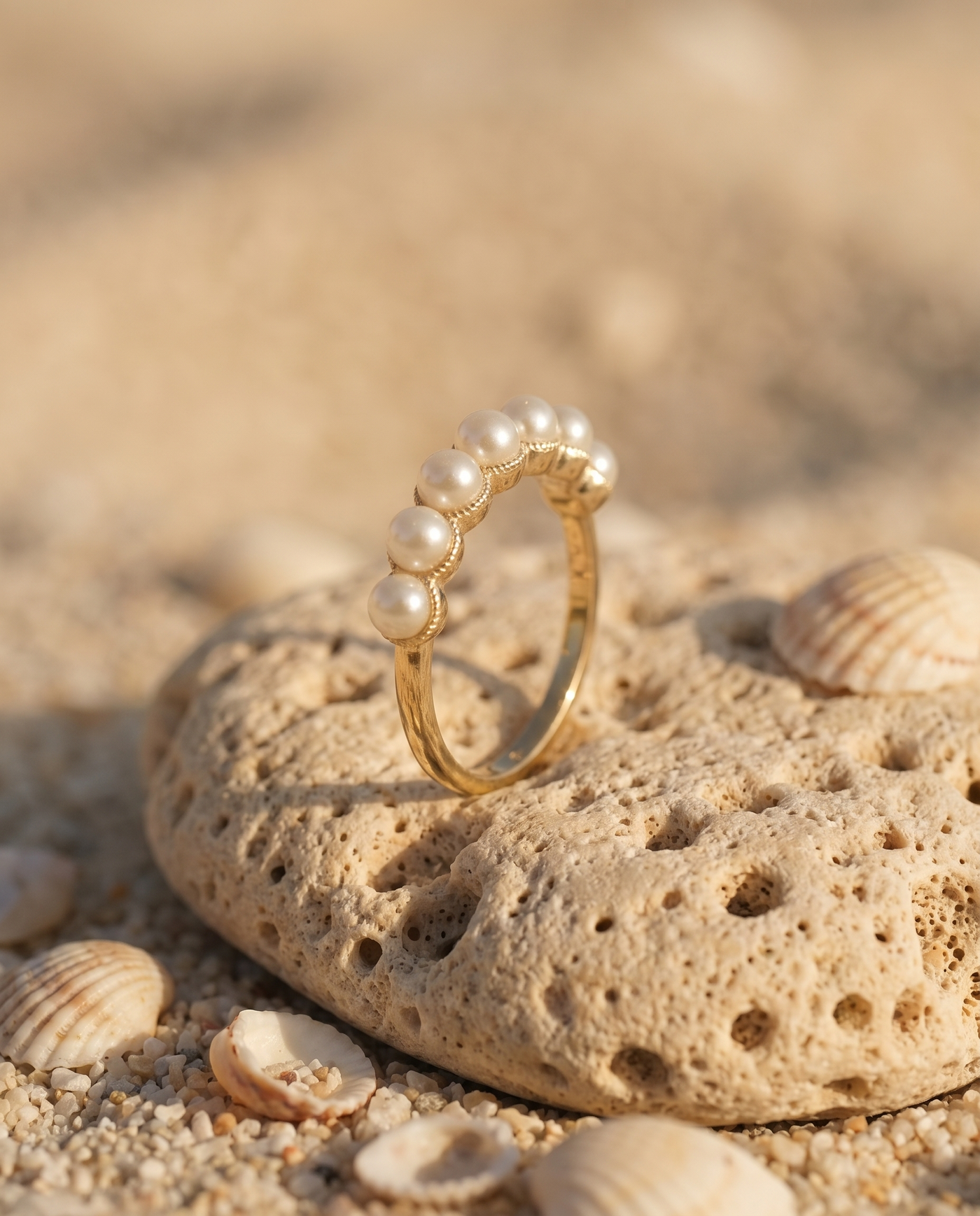Pearl Cascade Ring on an Aegean beach stone at golden hour