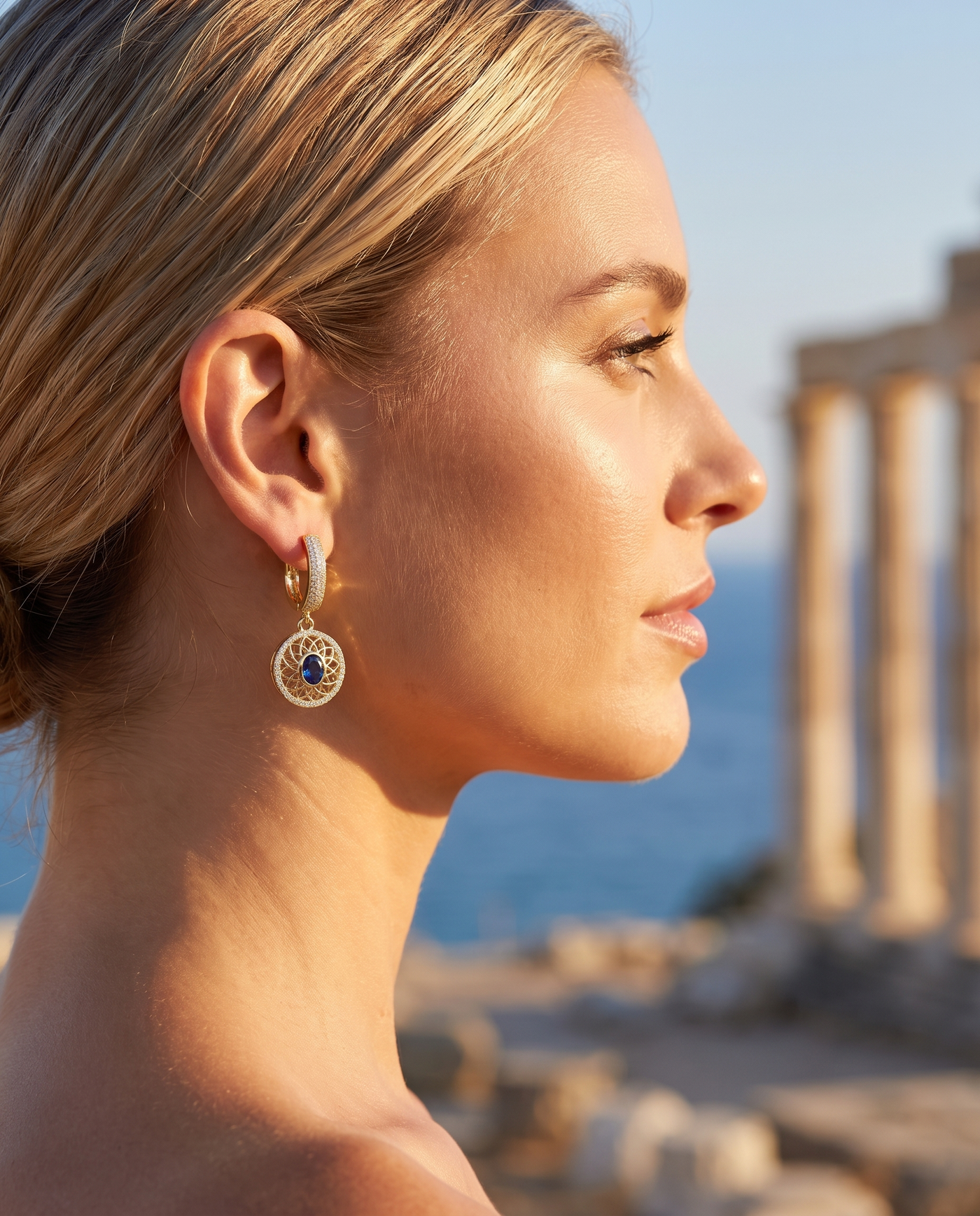 Elysian Earrings worn on the ear in profile overlooking the sea