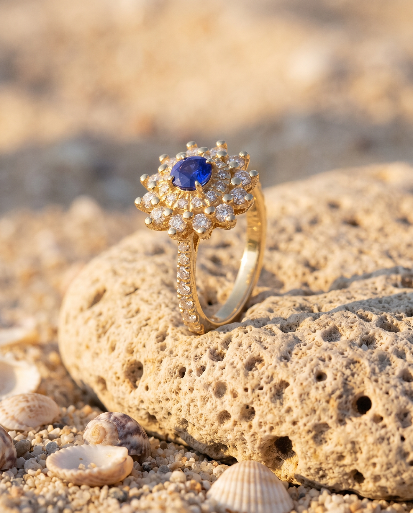 The Fiore Blue Sapphire Ring on an Aegean beach stone at golden hour