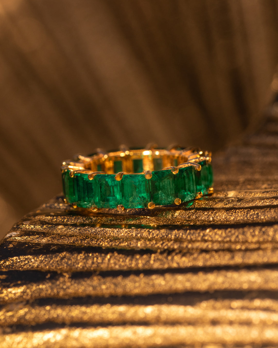 Eternal Emerald Ring by O Collection — 14k gold eternity band with emerald-cut green gemstones, full circle design inspired by Mediterranean elegance